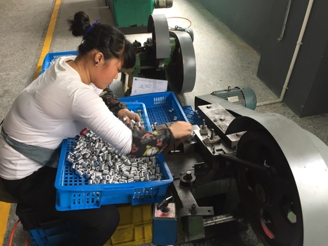 Stamping small metal parts… one at a time, by hand. They do a lot of work manually we would automate here. At $2.00 an hour for manufacturing wages, the cost is cheaper for them to do it manually.