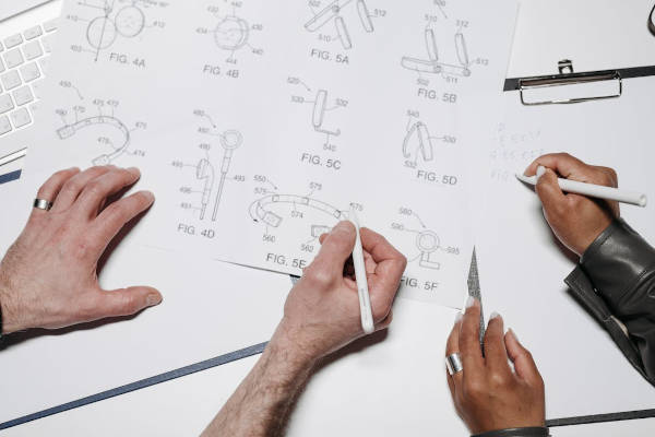 People drawing schematics for products